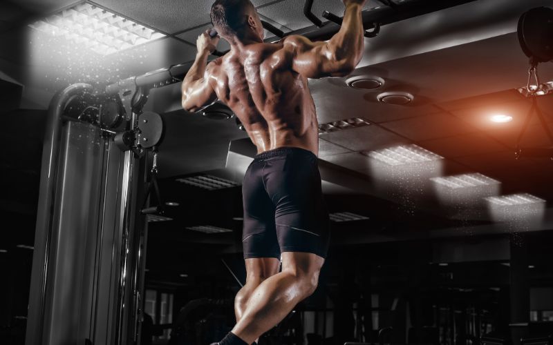 gym-supplements-muscle-athlete-man-in-gym-making-pull-up-min