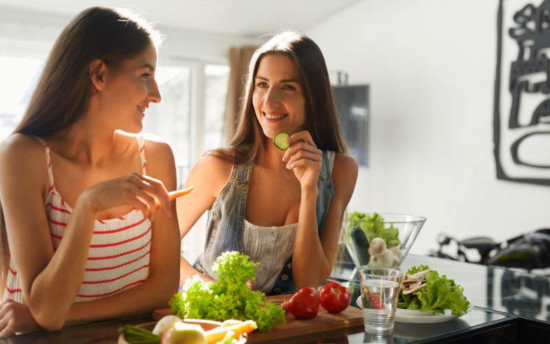NPL-supplements-healthy-eating-women-cooking-salad-in-kitchen-fitness-diet-food-min