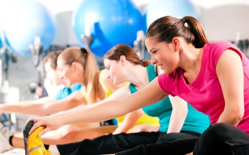 gym-supplements-people-in-gym-warming-up-stretching-min