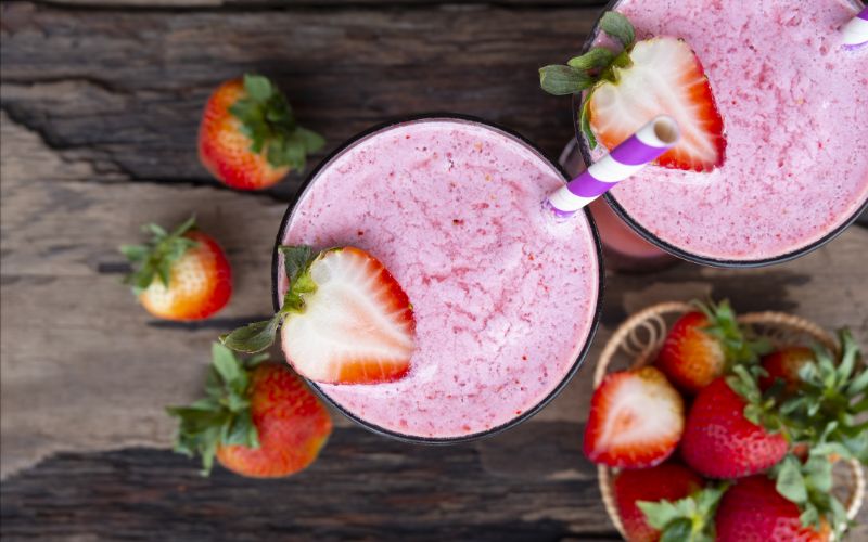 NPL-Whey-Protein-strawberry-smoothies-and-strawberry-fruit-for-for-milkshake-on-wooden-background-from-the-top-view-min