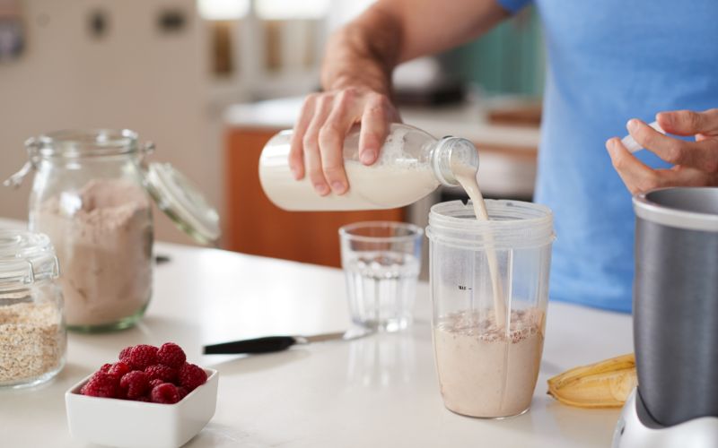 NPL Supplements-close-up-of-man-making-protein-shake-after-exercise-at-home-min